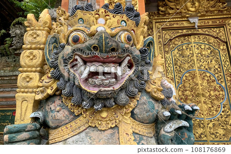 Traditional old ancient Balinese statue of demon angel called barong bali guarding sacred ritual temple 108176869
