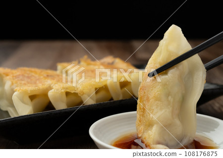 Fried gyoza with chopsticks Fried gyoza with chopsticks 108176875