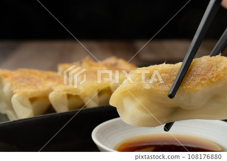 Fried gyoza with chopsticks 108176880
