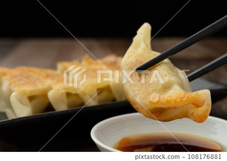 Fried gyoza with chopsticks Fried gyoza with chopsticks 108176881