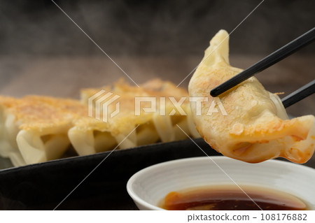 Fried gyoza with chopsticks 108176882