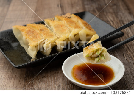 Fried gyoza with chopsticks 108176885