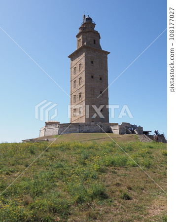 Grassy hill and tower of Hercules in A Coruna city in Spain - vertical Grassy hill and tower of Hercules in A Coruna city in Spain - vertical 108177027