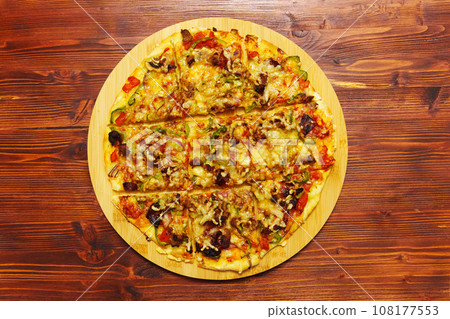 St. Louis-Style Pizza on a plate, cut into squares, on a wooden background. Flat lay 108177553