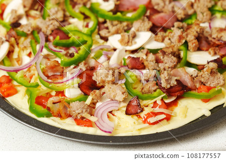 Raw homemade St Louis Style Pepperoni Pizza. No yeast, lots of bacon, onion and bell pepper Raw homemade St Louis Style Pepperoni Pizza. No yeast, lots of bacon, onion and bell pepper 108177557
