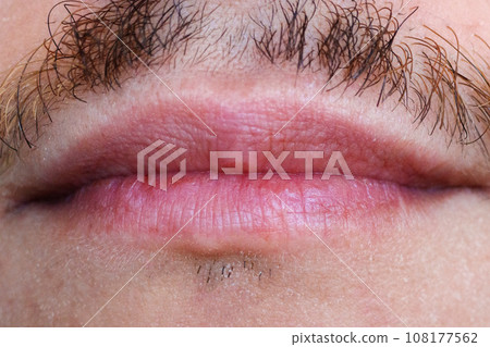 Mouth lips of a man with a mustache close-up macro. Selective focus Mouth lips of a man with a mustache close-up macro. Selective focus 108177562
