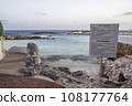 A sign of instructions on a rocky shoreline of a beach on a tropical island. 108177764