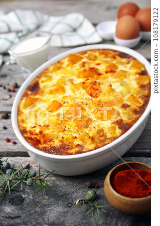 French cuisine. Vegetable pumpkin clafoutis in ceramic bakeware, smoked paprika dressing, eggs and cream 108179122