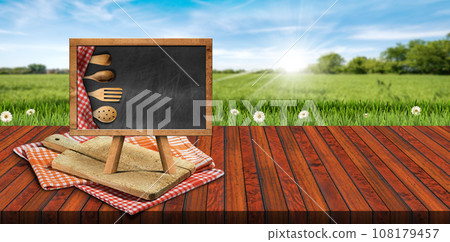 Cutting Board and Empty Blackboard on the Table on a Countryside Landscape 108179457