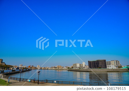 Blue skies on a clear autumn day as seen from the Nakagawa River flowing through Katsushika, Tokyo Blue skies on a clear autumn day as seen from the Nakagawa River flowing through Katsushika, Tokyo 108179515
