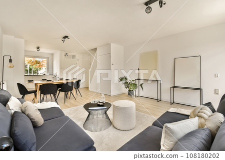 a living room with couches, chairs and a dining area in the back wall is an open space for people to work a living room with couches, chairs and a dining area in the back wall is an open space for people to work 108180202