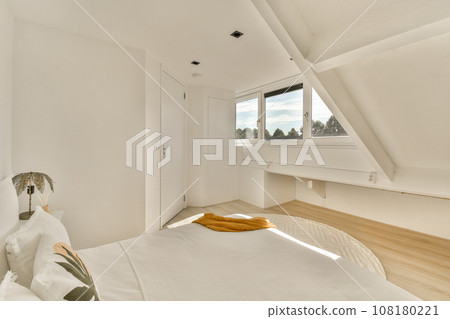 a bedroom with white walls and wood flooring on the wall, there is a large window that looks out to the city a bedroom with white walls and wood flooring on the wall, there is a large window that looks out to the city 108180221