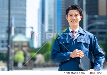 A middle-aged businessman working in work clothes in an office district A middle-aged businessman working in work clothes in an office district 108180543