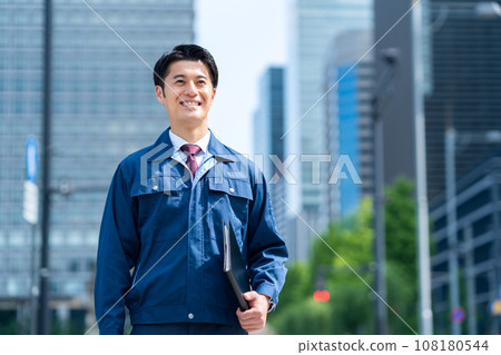 A middle-aged businessman working in work clothes in an office district A middle-aged businessman working in work clothes in an office district 108180544