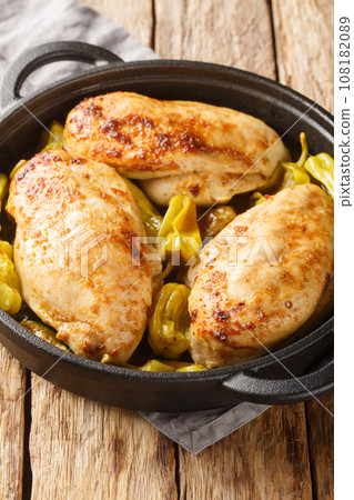 Oven Baked Mississippi Chicken with ranch seasoning, dried au jus gravy mix and pepperoncini peppers closeup on the pan. Vertical Oven Baked Mississippi Chicken with ranch seasoning, dried au jus gravy mix and pepperoncini peppers closeup on the pan. Vertical 108182089