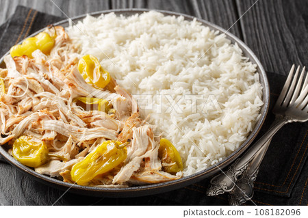 Mississippi Pulled Chicken with ranch seasoning, dried au jus gravy mix and pepperoncini peppers served with rice closeup on the plate. Horizontal Mississippi Pulled Chicken with ranch seasoning, dried au jus gravy mix and pepperoncini peppers served with rice closeup on the plate. Horizontal 108182096