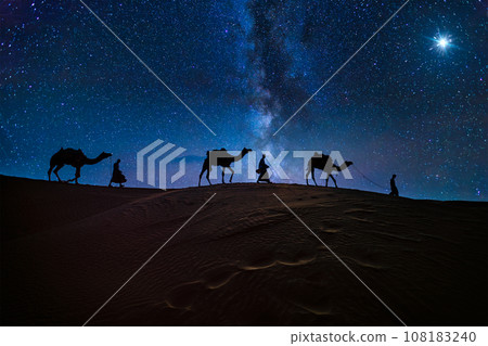 Christmas Jesus birth concept - Adoration of the Magi, Three Wise Men, Three Kings, and the Three biblical Magi with camel silhouettes journeying in sand dunes of desert follow Bethlehem star at night Christmas Jesus birth concept - Adoration of the Magi, Three Wise Men, Three Kings, and the Three biblical Magi with camel silhouettes journeying in sand dunes of desert follow Bethlehem star at night 108183240