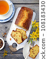Summer dessert. Raisin cake, cup of tea and bouquet of forsythia 108183430