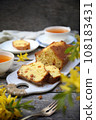 Summer dessert. Raisin cake, cups of tea and bouquet of forsythia, rustic style on wooden background 108183431