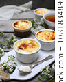 Sutlac. Traditional Turkish rice dessert. Rice pudding, four servings and tea and spring white flowers 108183489