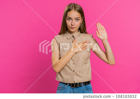 Woman raising hand to take oath, promising to be honest and to tell truth, keeping hand on chest 108183832