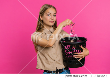 Woman taking off, throwing out glasses into bin after medical vision laser treatment therapy surgery 108183845