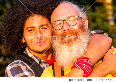 Love Knows No Bounds: Joyful Gay Couple Embracing in Nature 108185650