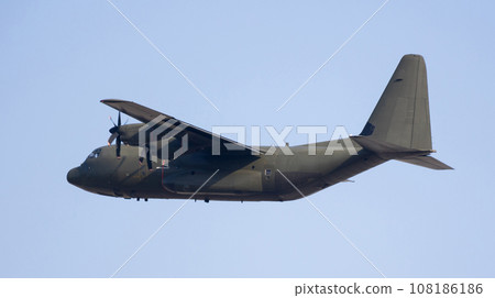 Four-engine military turboprop cargo aircraft soaring through sky Four-engine military turboprop cargo aircraft soaring through sky 108186186