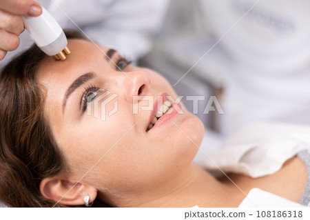Young woman having face radiolifting procedure 108186318