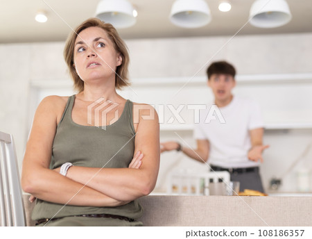 Guy screams during family quarrel with woman in kitchen 108186357