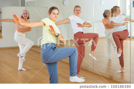 Teenage girl dancing with her family in studio Teenage girl dancing with her family in studio 108186380