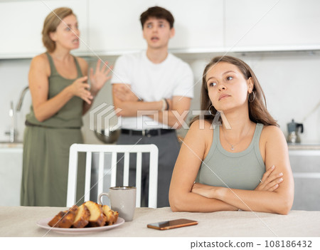Woman mother and young guy during family quarrel accuse adult daughter Woman mother and young guy during family quarrel accuse adult daughter 108186432