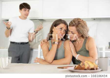 Mom calms her daughter down during domestic quarrel with her young husband 108186434