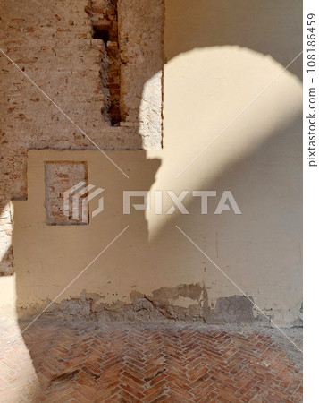 The fragment the brick wall with warm light and shadows. 108186459