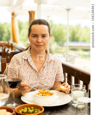 Portrait of woman having lunch gazpacho traditional dish of Spanish cuisine 108186861