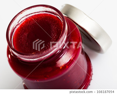 Closeup of raspberry jam in glass jar Closeup of raspberry jam in glass jar 108187054