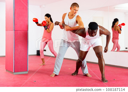Men and woman exercising self-protection martial arts in gym 108187114
