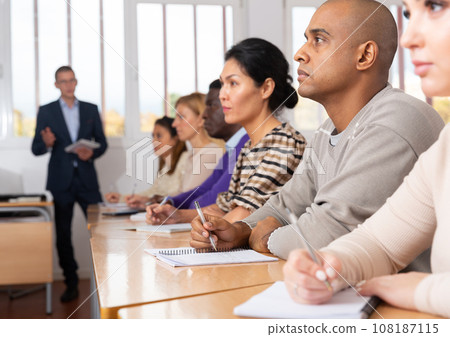 Focused man working at adult education class 108187115