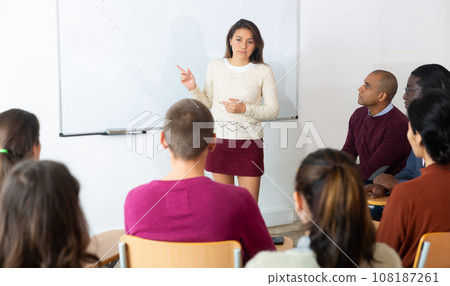 Lecturer talking to students during seminar 108187261