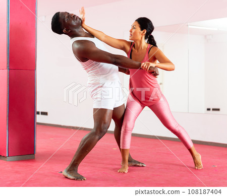 Man and woman exercising moves on self-defence training 108187404