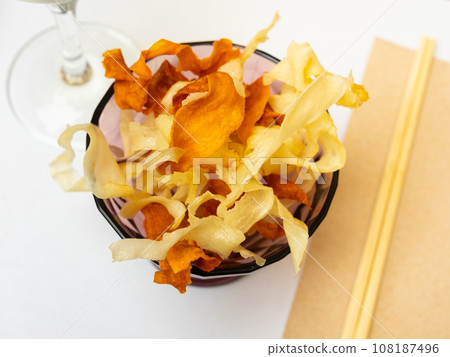 Pile of vegetable chips of sweet potato and yuca in bowl 108187496
