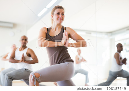 Scene of a group of people practicing couples yoga 108187549