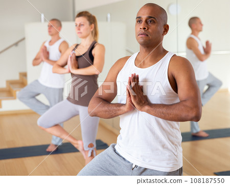 Man making yoga exercises at group class 108187550
