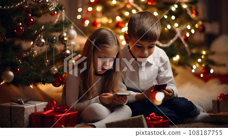 Children look at the screens of electronic devices with interest Children look at the screens of electronic devices with interest 108187755