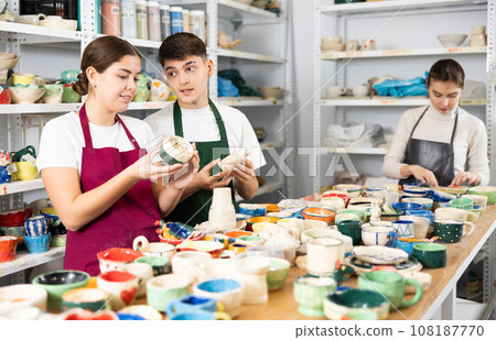 Man and women viewing handmade clay products 108187770