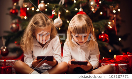 Children look at the screens of electronic devices with interest  108187771
