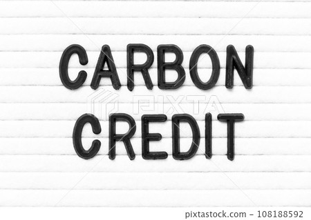 Black color letter in word carbon credit on white felt board background Black color letter in word carbon credit on white felt board background 108188592