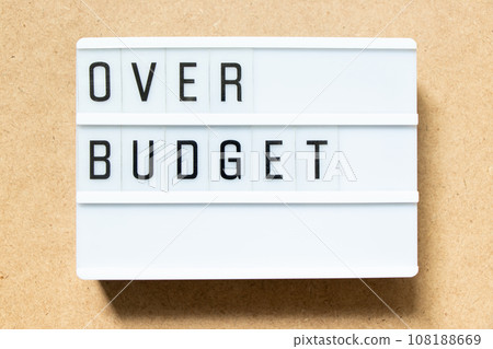 Lightbox with word over budget on wood background Lightbox with word over budget on wood background 108188669