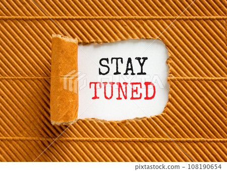 Stay tuned symbol. Concept words Stay tuned on beautiful white paper on a beautiful brown paper background. Business, support, motivation, psychological and stay tuned concept. Copy space. 108190654