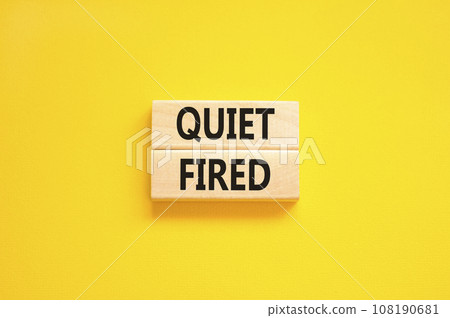 Quiet fired symbol. Concept words Quiet fired on wooden blocks. Beautiful yellow table yellow background. Business and quiet fired concept. Copy space. 108190681